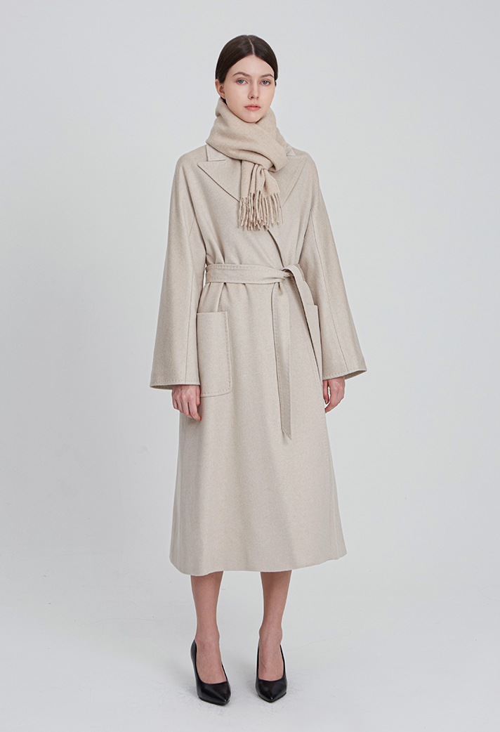 Woman in a long wool coat with silk scarf and heels